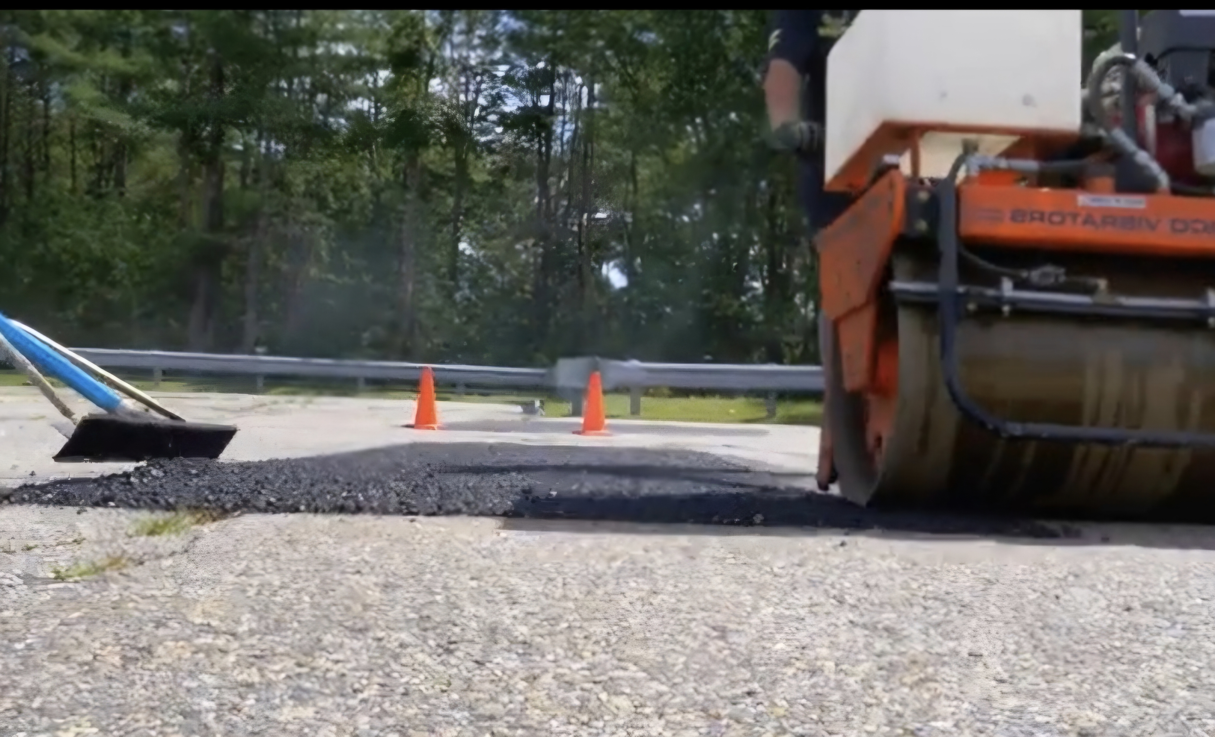 Utility cut restoration with roller and traffic cones